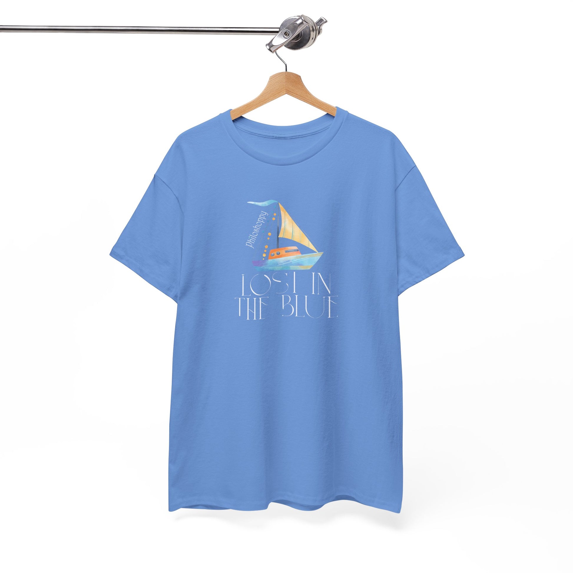 Carolina blue cotton T-shirt from Philoshoppy featuring a sailing boat illustration and the phrase 'lost in the blue', expressing ocean calm, wanderlust, and sea-inspired freedom.