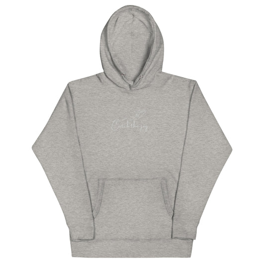 Grey unisex cotton hoodie with “Catch the Joy” embroidery, soft, cozy fabric with minimalist design and relaxed fit.