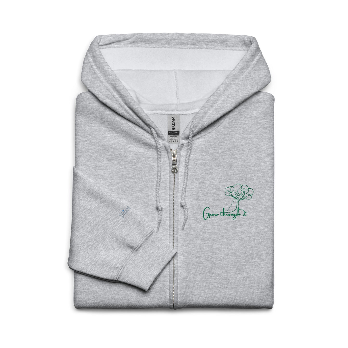 Grey unisex cotton zipped hoodie featuring “Grow Through It” embroidery with a minimalist tree, a gentle reminder that every challenge holds the seed of growth.
