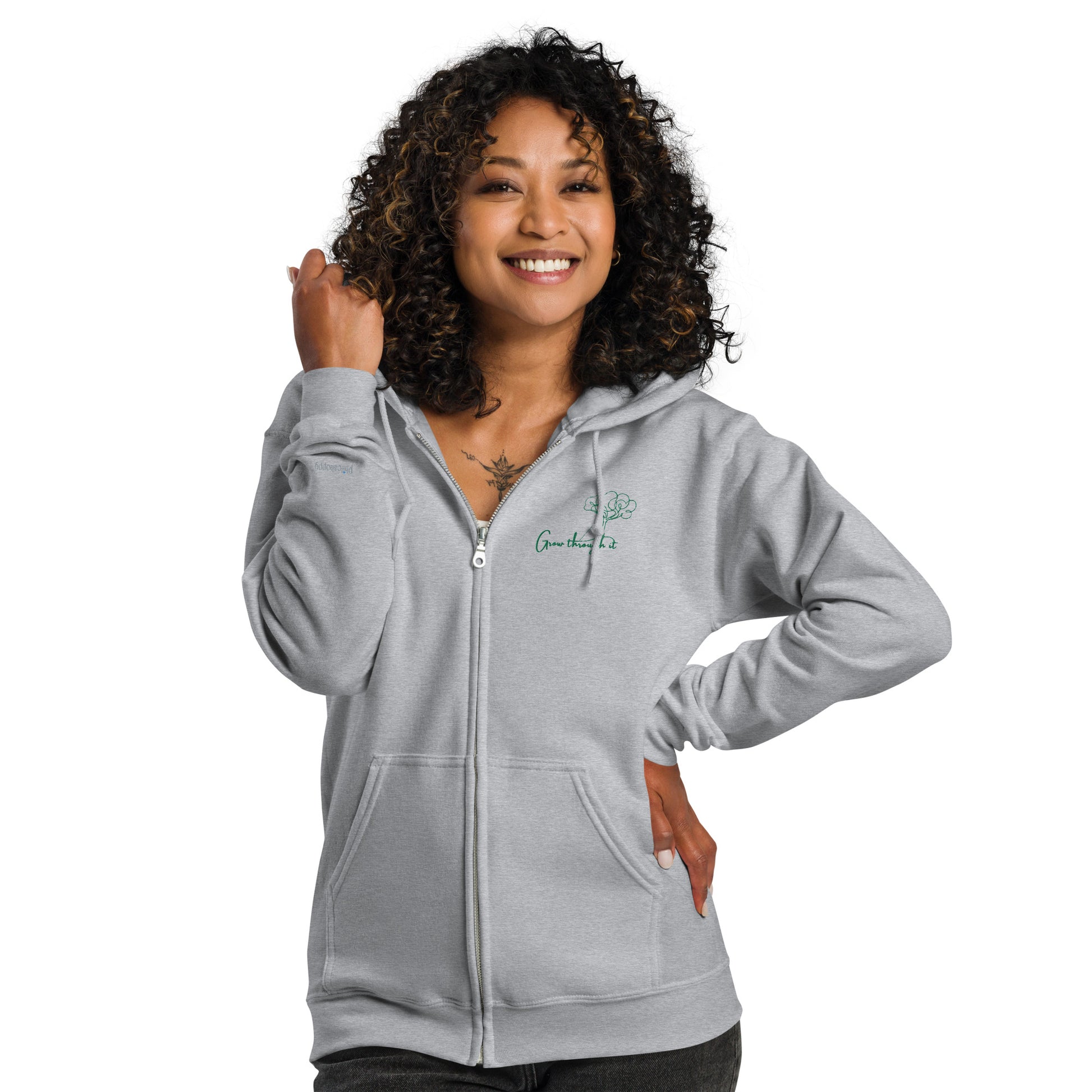 Grey unisex cotton zipped hoodie with “Grow Through It” embroidery and minimal tree design, soft, relaxed fit.