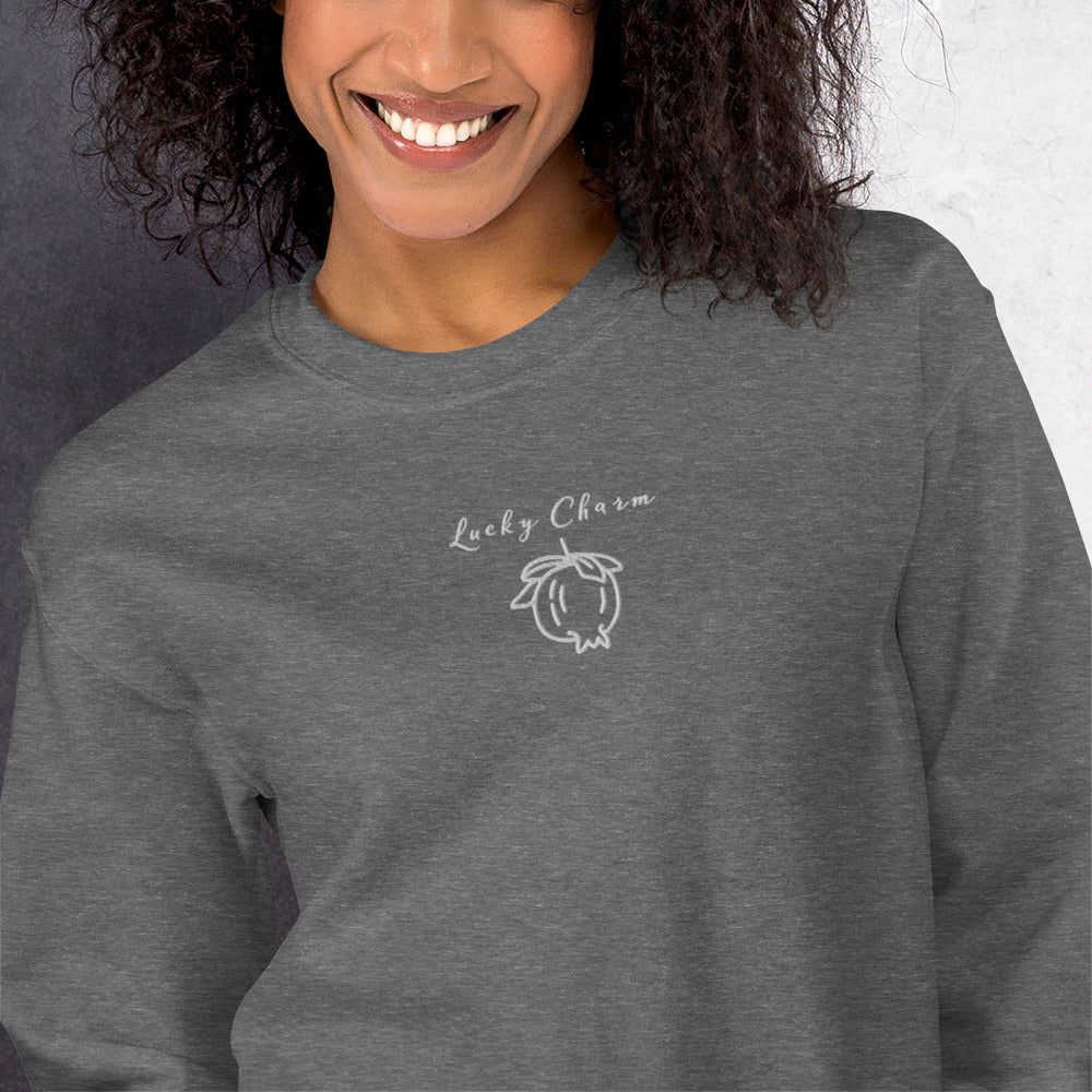 Grey cotton sweatshirt featuring “Lucky Charm” embroidery and minimal pomegranate, a wearable reminder to cultivate gratitude, optimism, and small joys in everyday life.