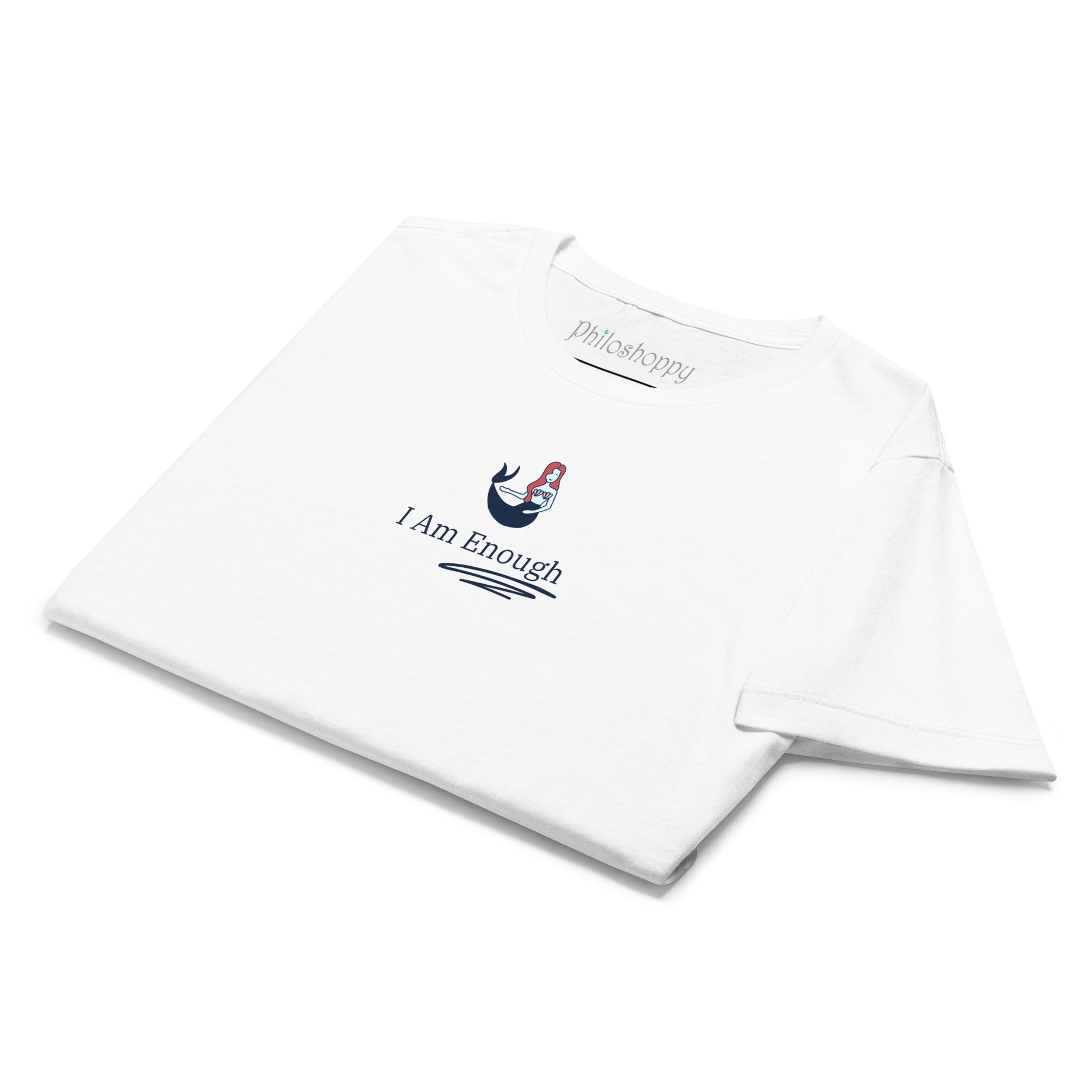 Folded white women’s softstyle T-shirt with “I Am Enough” text and mermaid illustration, ready to wear or gift.