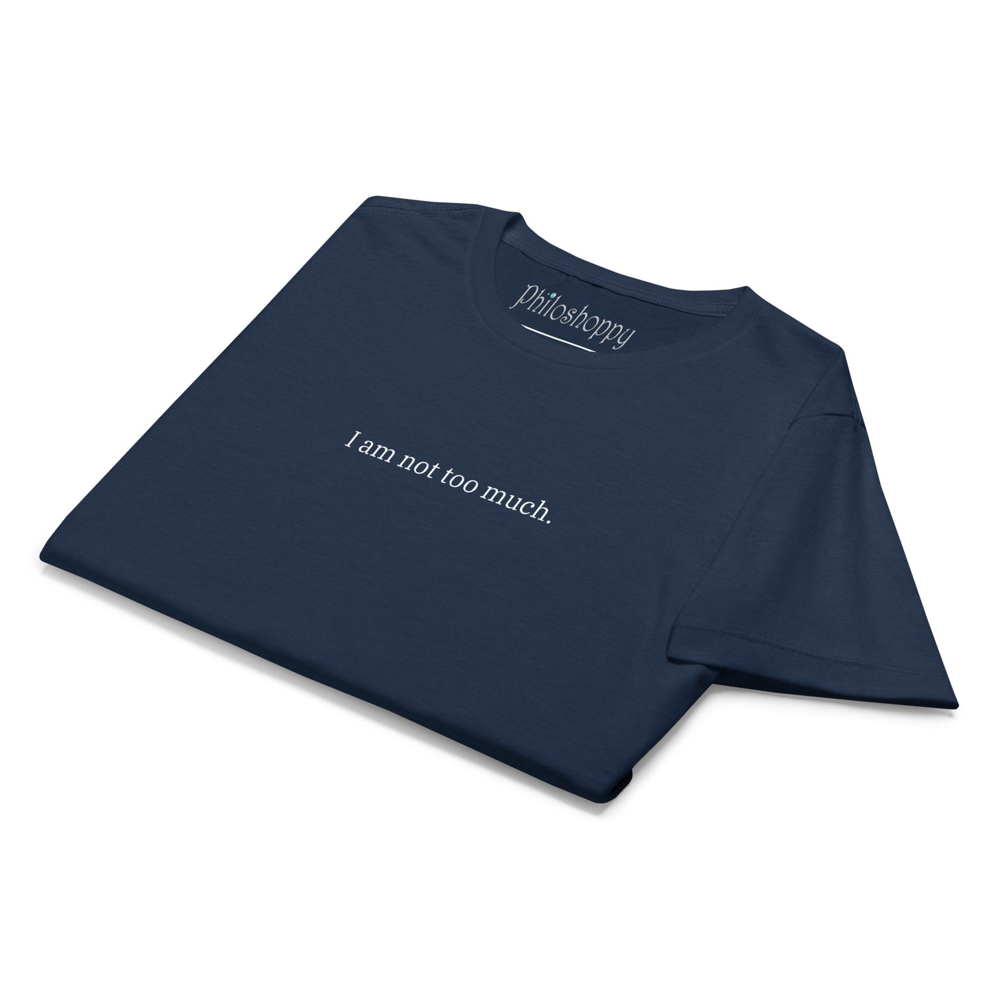 Folded navy women’s softstyle T-shirt with “I Am Not Too Much” text and subtle feminine symbol graphic, ready to wear or gift.