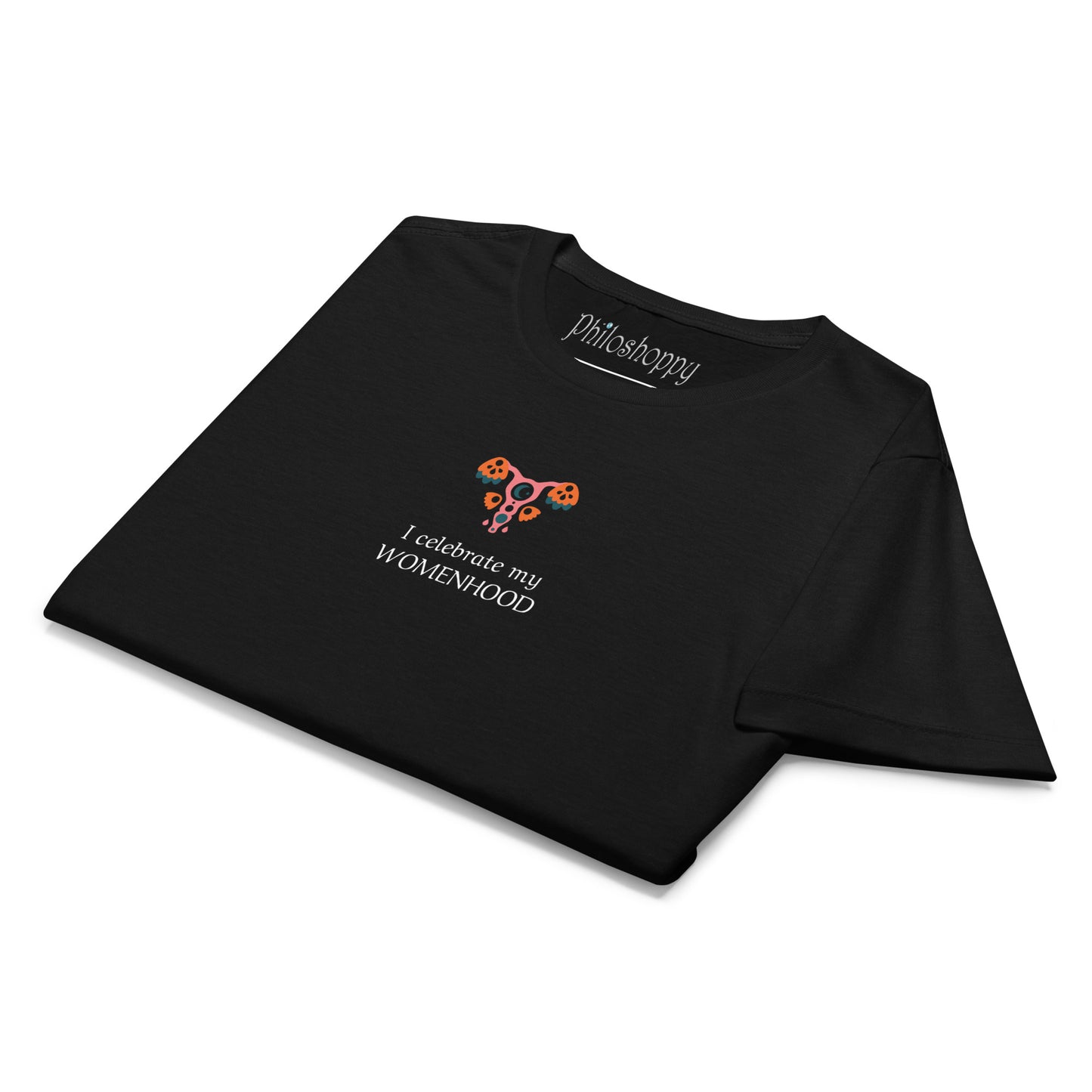 Folded  black women’s softstyle T-shirt with “I Celebrate My Womanhood” text and feminine symbol graphic.