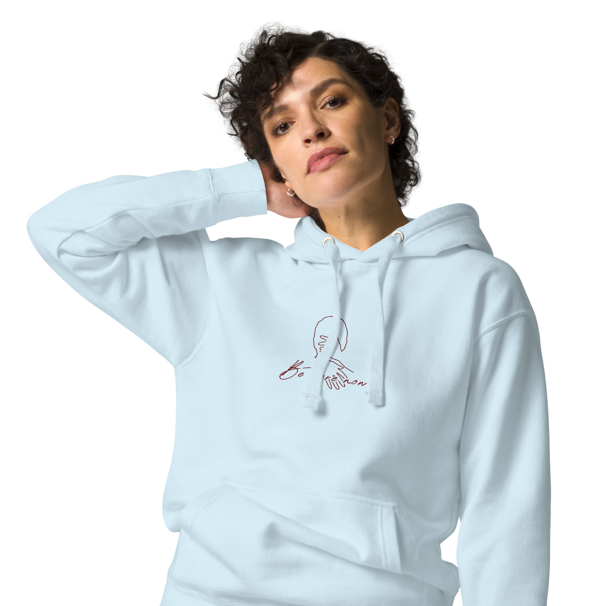 Relaxed light blue hoodie with “Be Here Now” text — unisex design symbolizing mindfulness, calm, and intentional living.