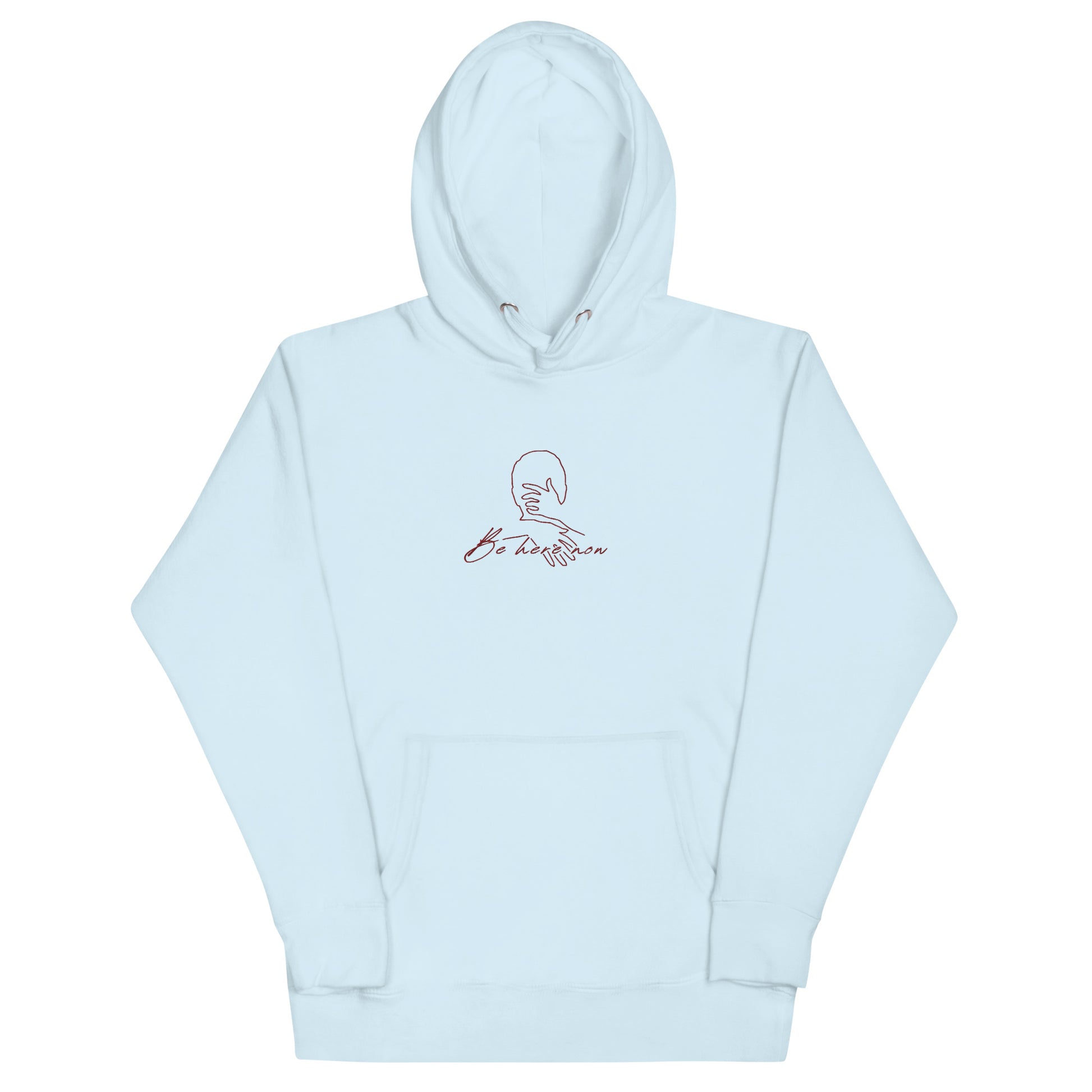 Relaxed light blue hoodie with “Be Here Now” text , unisex design symbolizing mindfulness, calm, and intentional living.