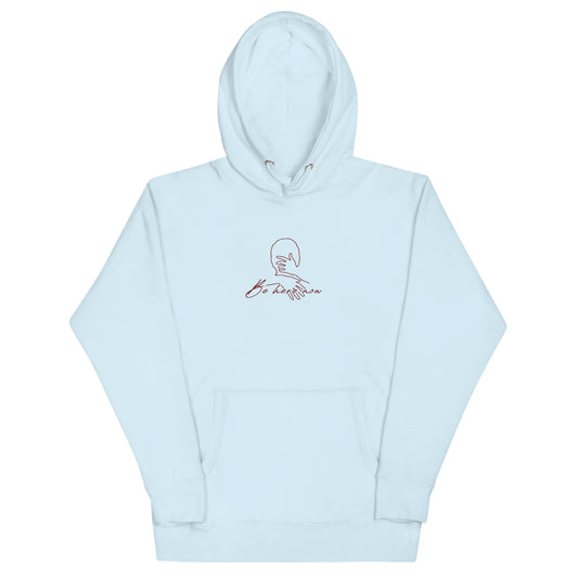 Relaxed light blue hoodie with “Be Here Now” text , unisex design symbolizing mindfulness, calm, and intentional living.