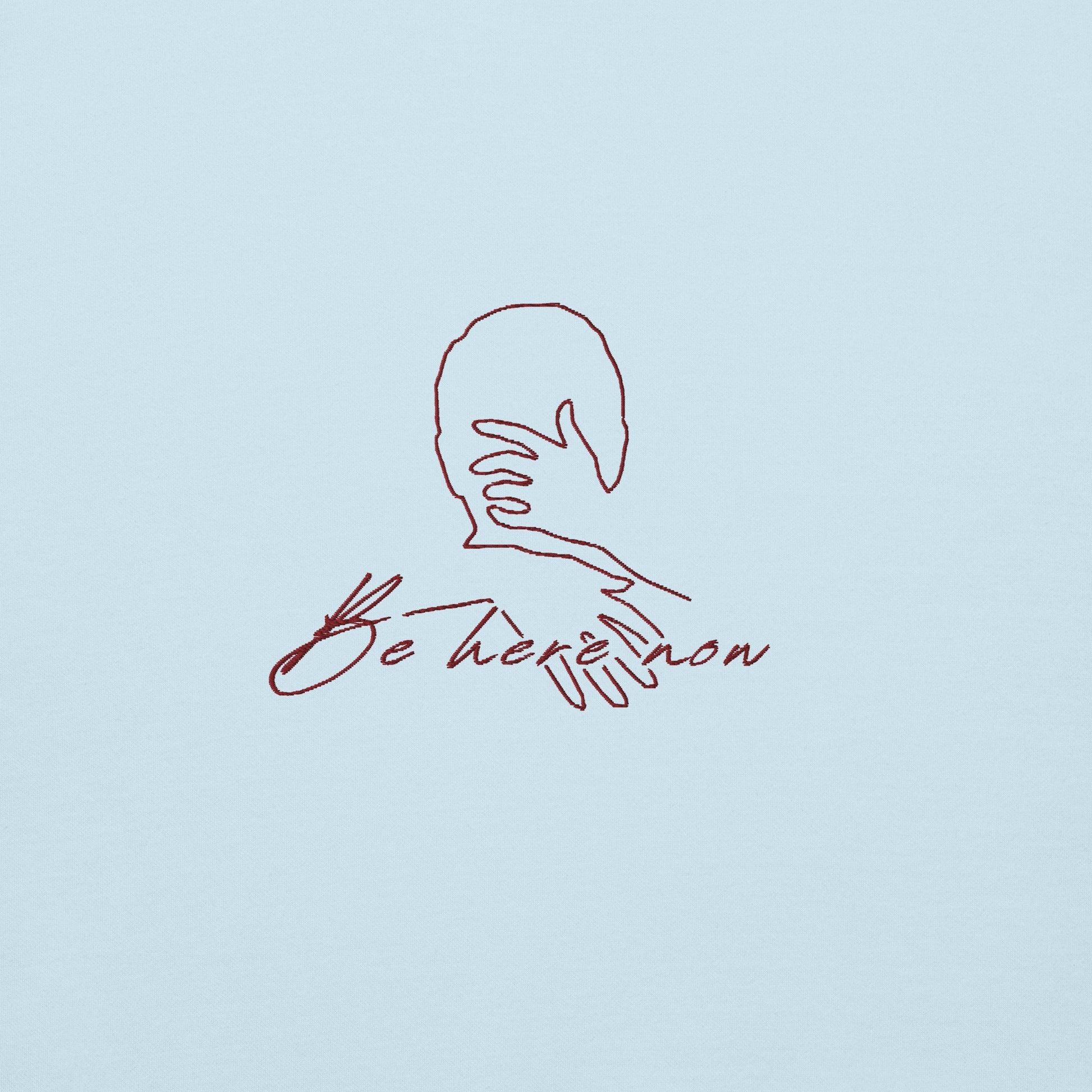 Light blue unisex cotton hoodie with minimalist “Be Here Now” print,  soft, cozy fabric for everyday comfort.