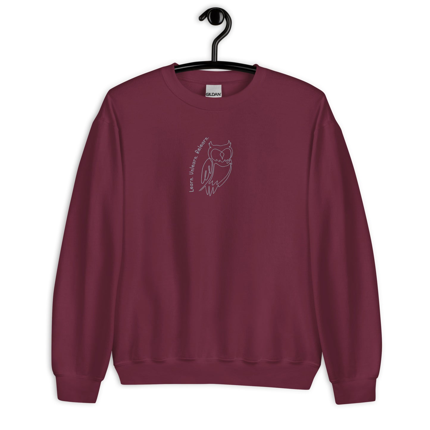 Maroon unisex cotton sweatshirt with “Learn. Unlearn. Relearn.” embroidery and owl design, soft, relaxed fit.