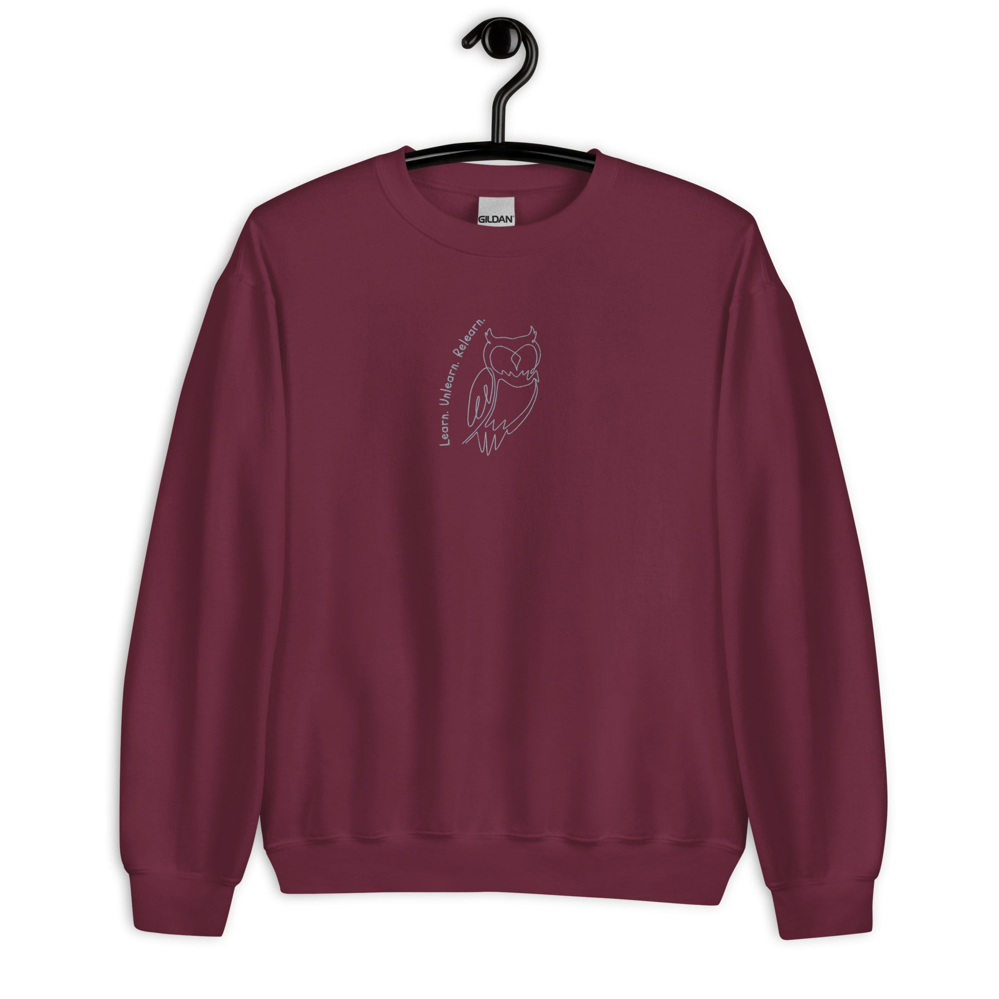 Maroon unisex cotton sweatshirt with “Learn. Unlearn. Relearn.” embroidery and owl design, soft, relaxed fit.