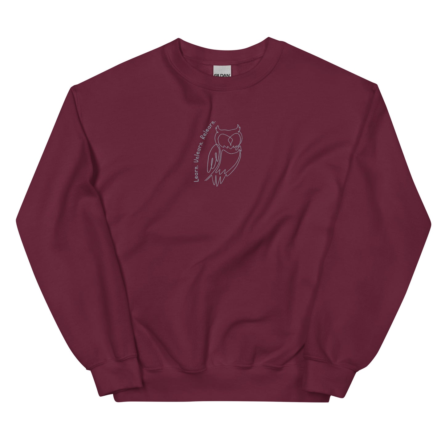 Maroon cotton sweatshirt featuring Learn. Unlearn. Relearn. embroidery with an owl, a wearable reminder that growth is a continuous journey of insight, humility, and adaptability.