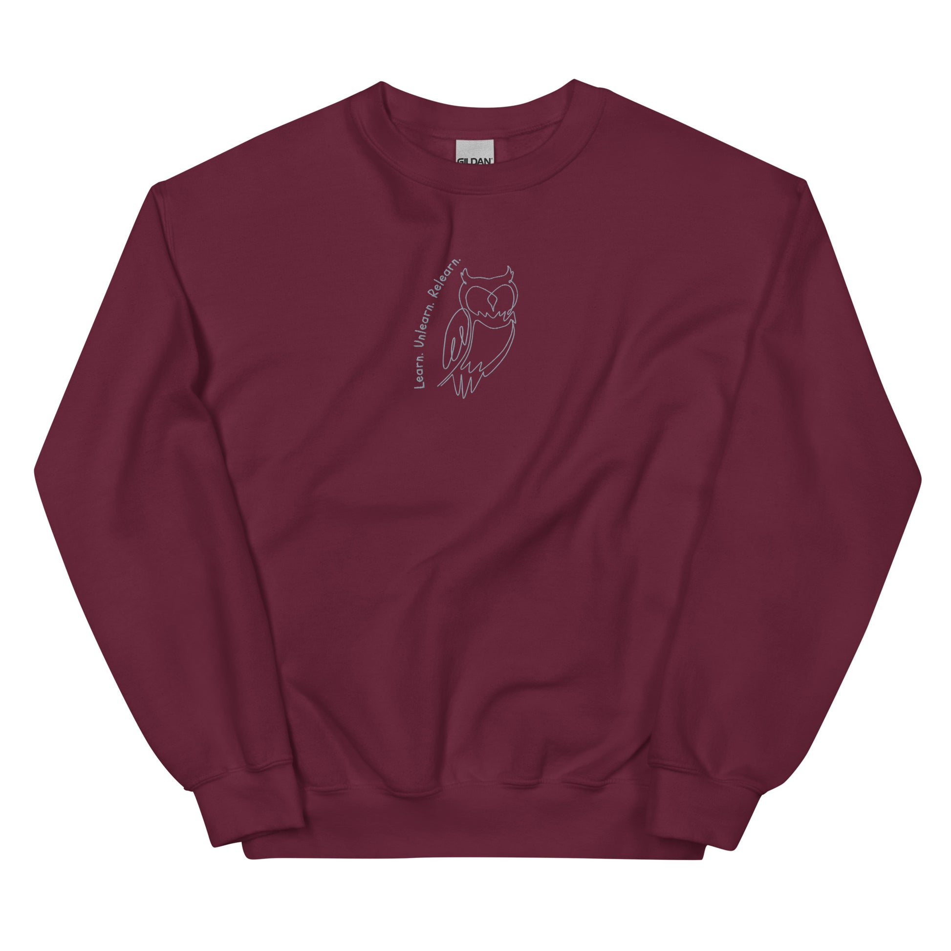 Maroon cotton sweatshirt featuring Learn. Unlearn. Relearn. embroidery with an owl, a wearable reminder that growth is a continuous journey of insight, humility, and adaptability.