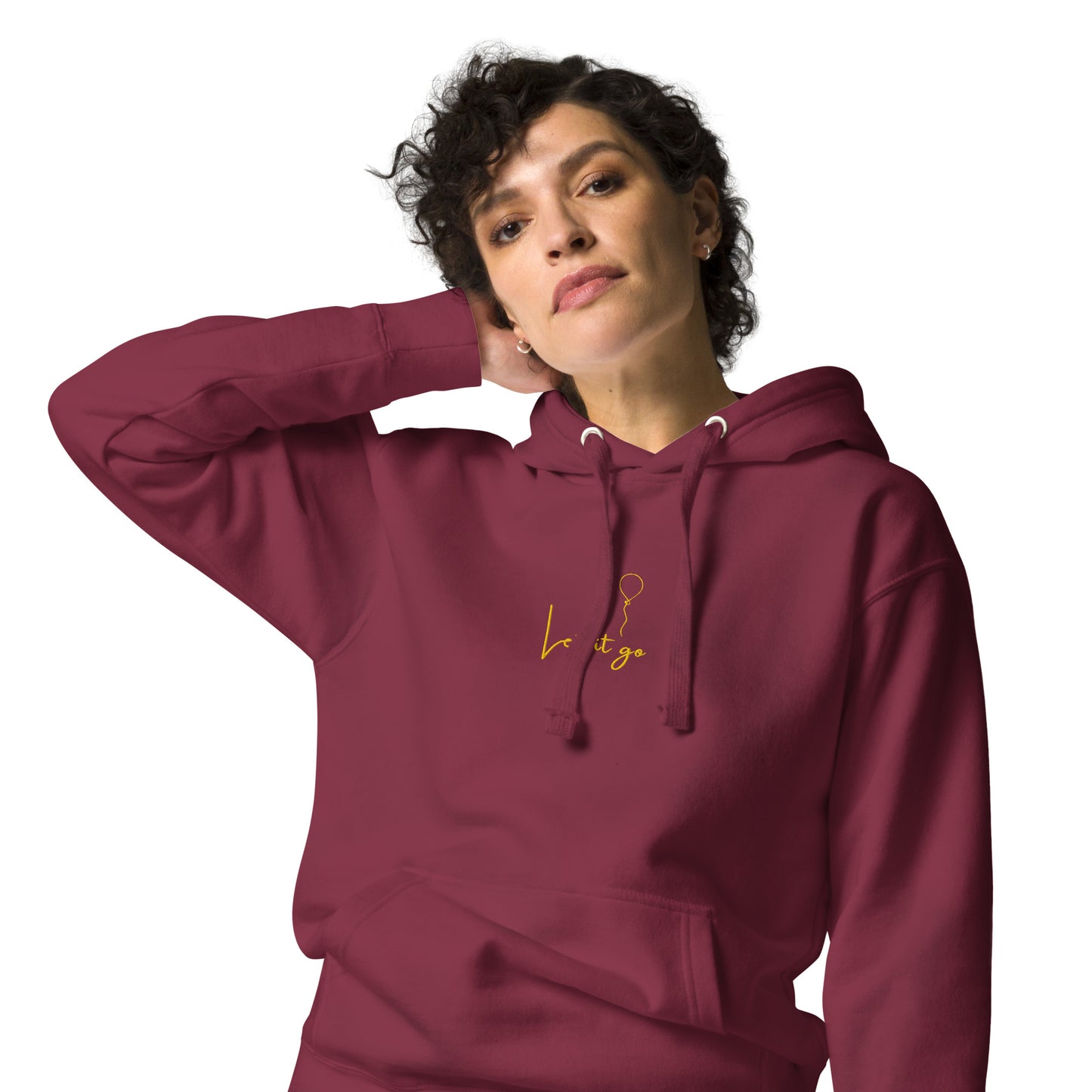 Relaxed maroon hoodie featuring “Let It Be” embroidered text; unisex style symbolizing peace, acceptance, and mindful living.