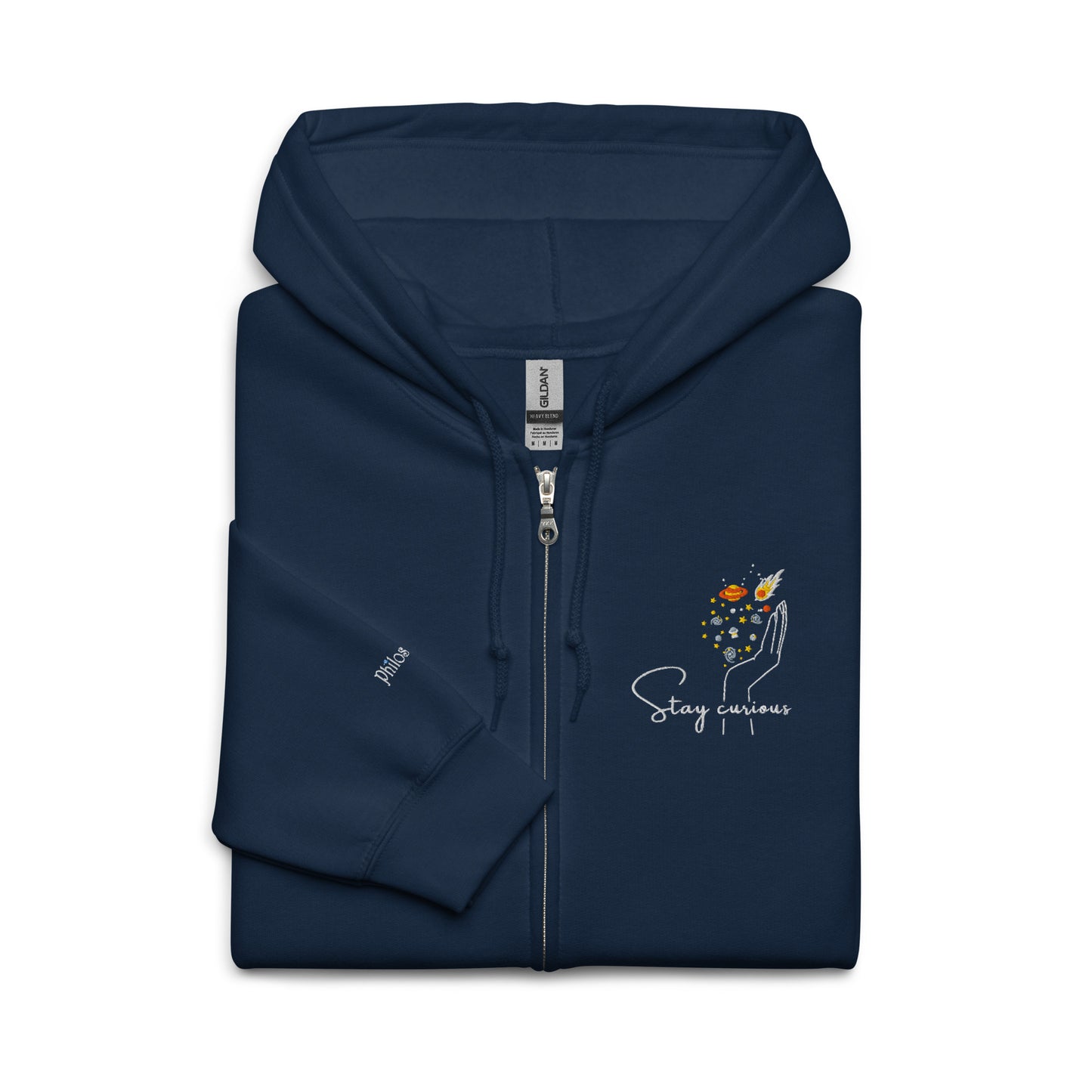Closeup up of Navy blue cotton hoodie featuring “Stay Curious” and a hand cradling the galaxy, a wearable reminder to keep exploring the unknown with openness and awe.