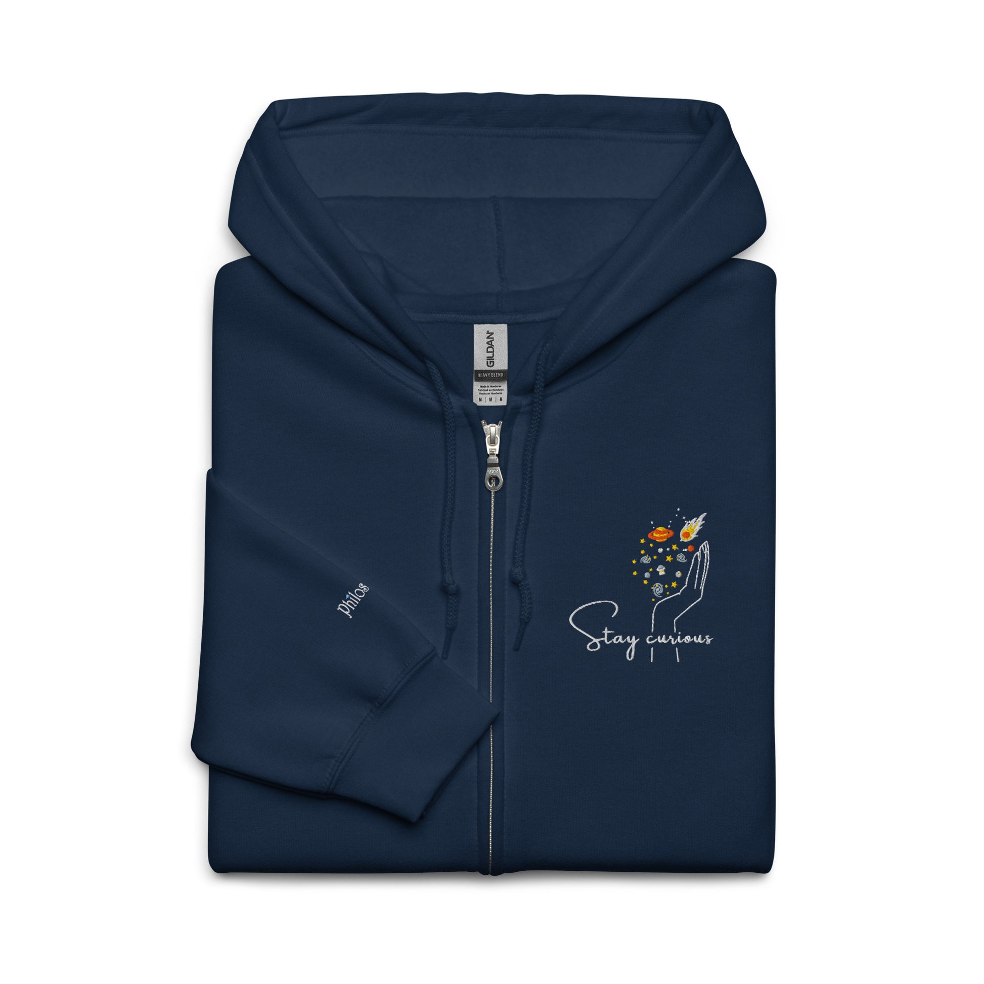 Closeup up of Navy blue cotton hoodie featuring “Stay Curious” and a hand cradling the galaxy, a wearable reminder to keep exploring the unknown with openness and awe.