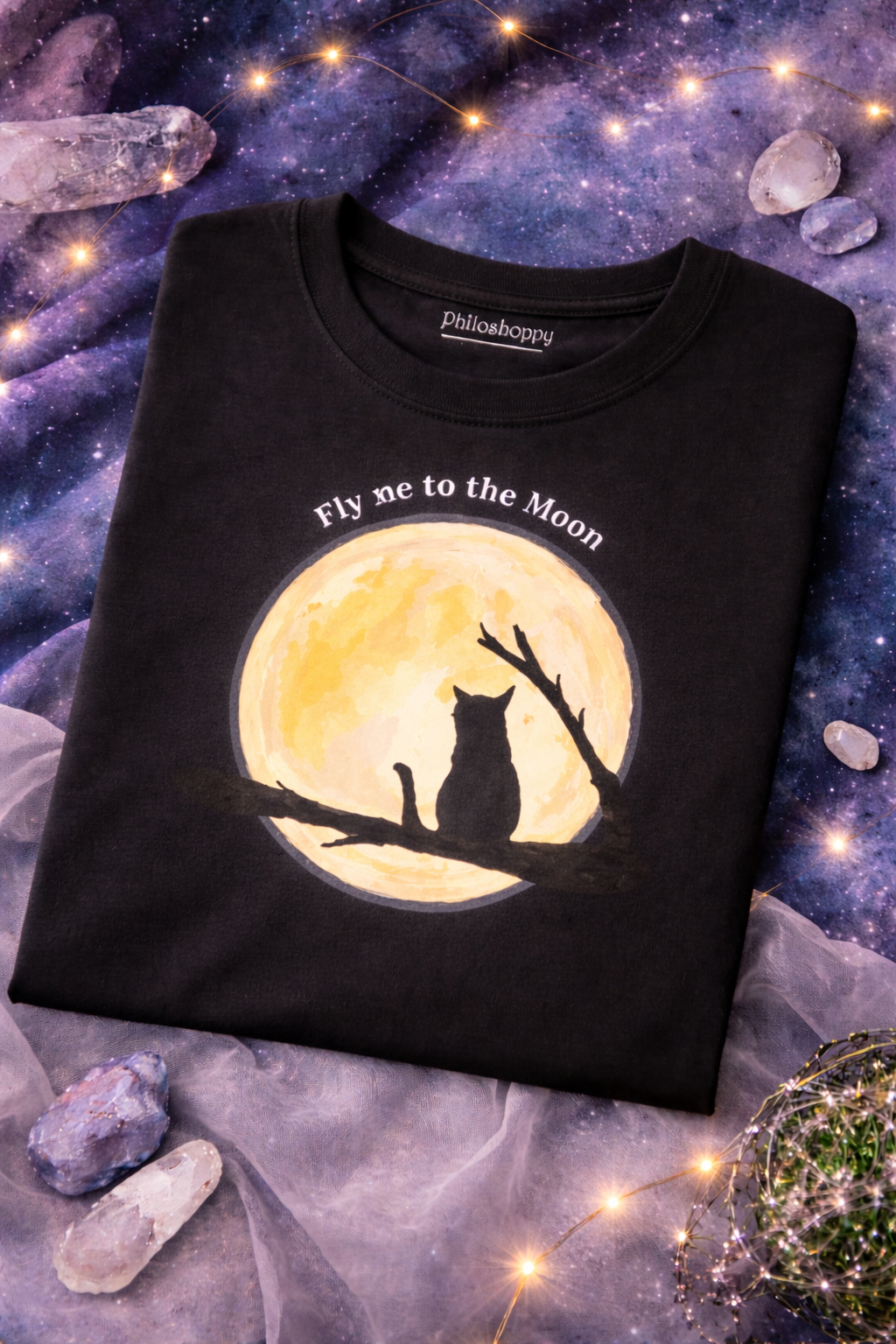 Black t-shirt with a cat and moon design on a mystical background with crystals and lights.