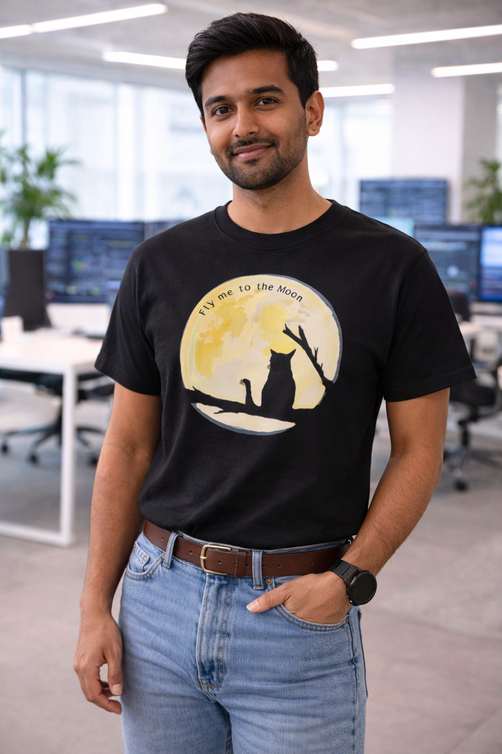 Man wearing black Fly Me to the Moon cat moon graphic t-shirt styled casually