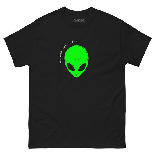 Black unisex We Are Not Alone graphic t-shirt featuring green alien artwork and sci-fi text