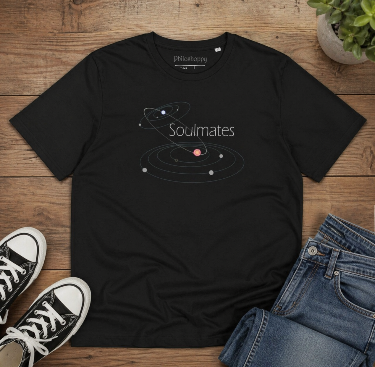 Black t-shirt with 'Soulmates' design on a wooden surface with jeans and sneakers.