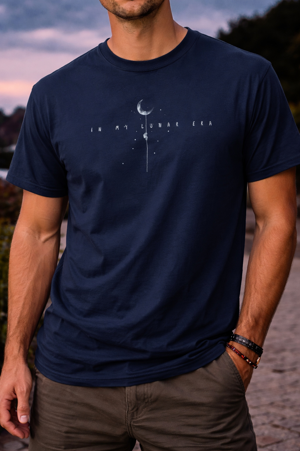 Person wearing navy Lunar Era astronaut t-shirt styled casually