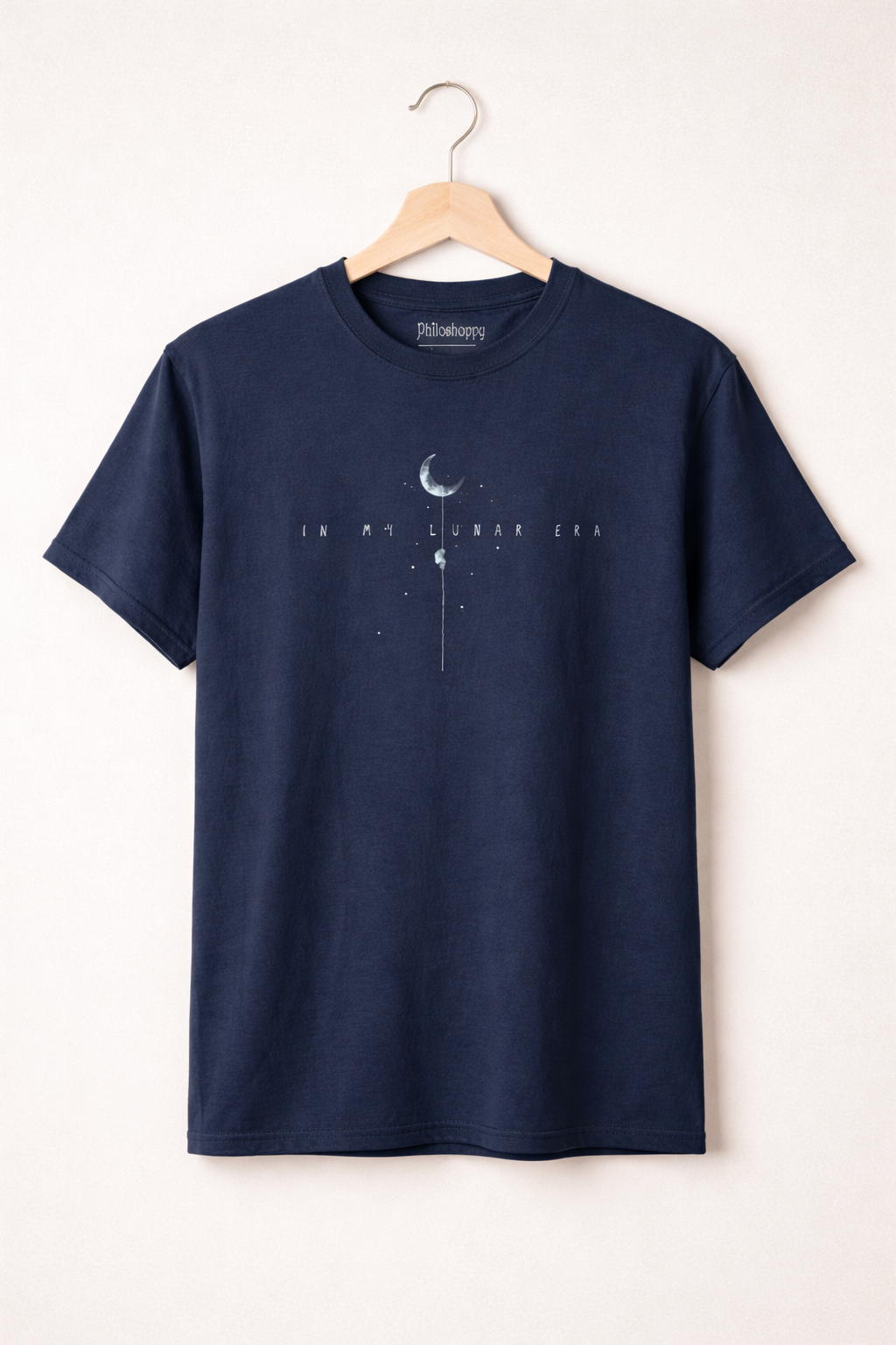 Navy blue t-shirt with a graphic design on a hanger against a white background