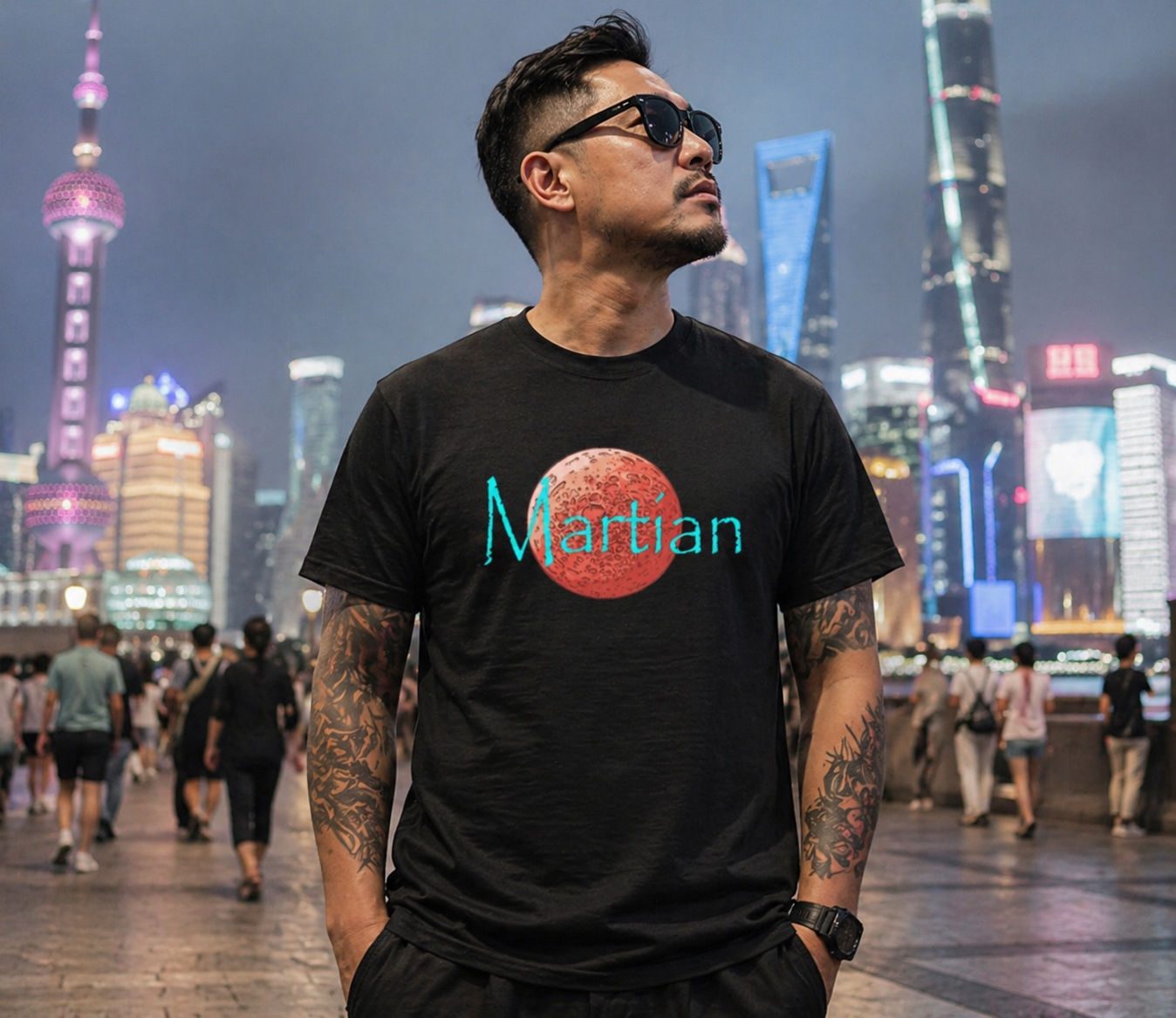 Man wearing a philoshoppy black t-shirt with 'Martian' logo in an urban night setting