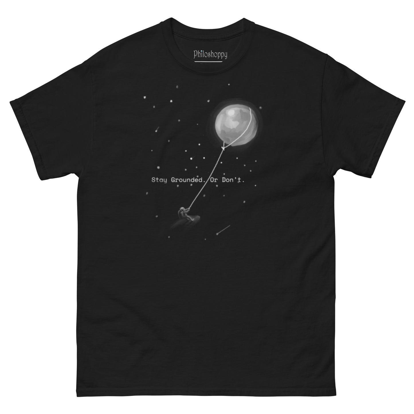 Black unisex Stay Grounded t-shirt featuring astronaut kite surfing with moon as kite surreal space design
