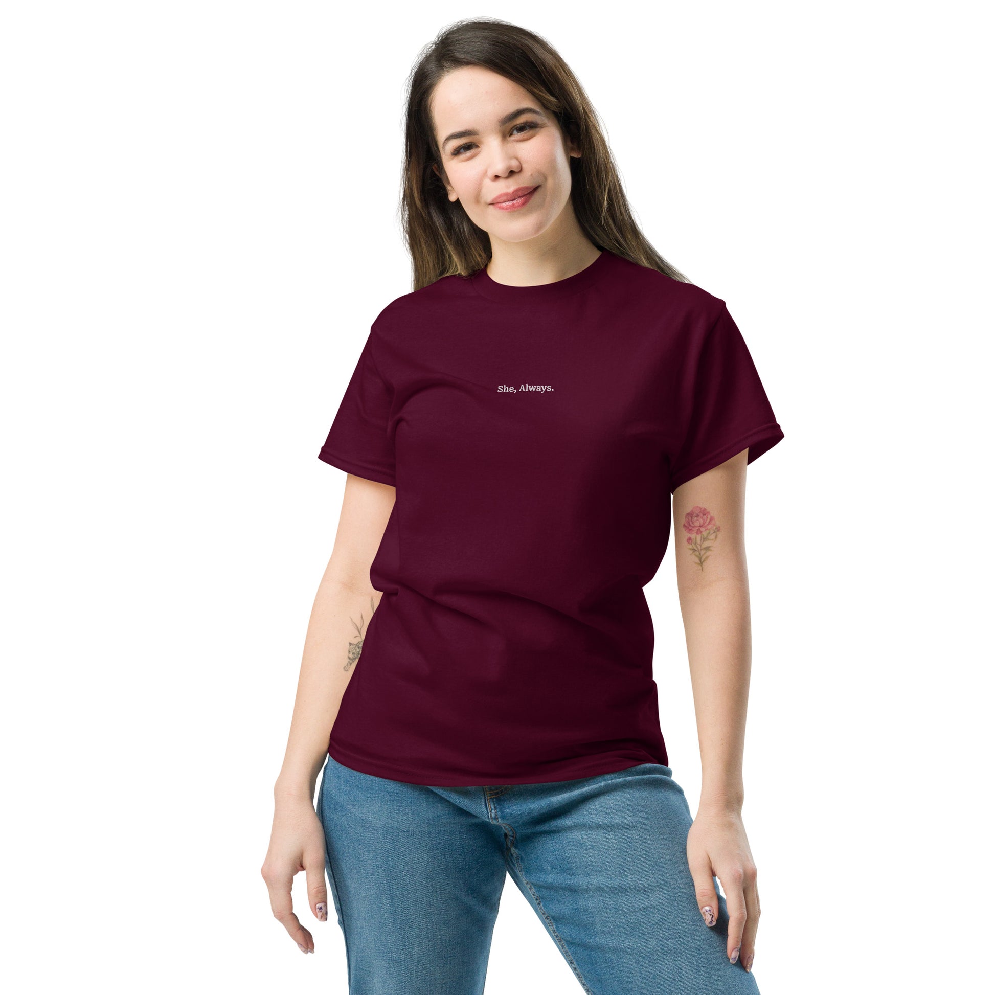 Female model wearing maroon “She. Always.” unisex cotton T-shirt, celebrating women’s strength and consistency.