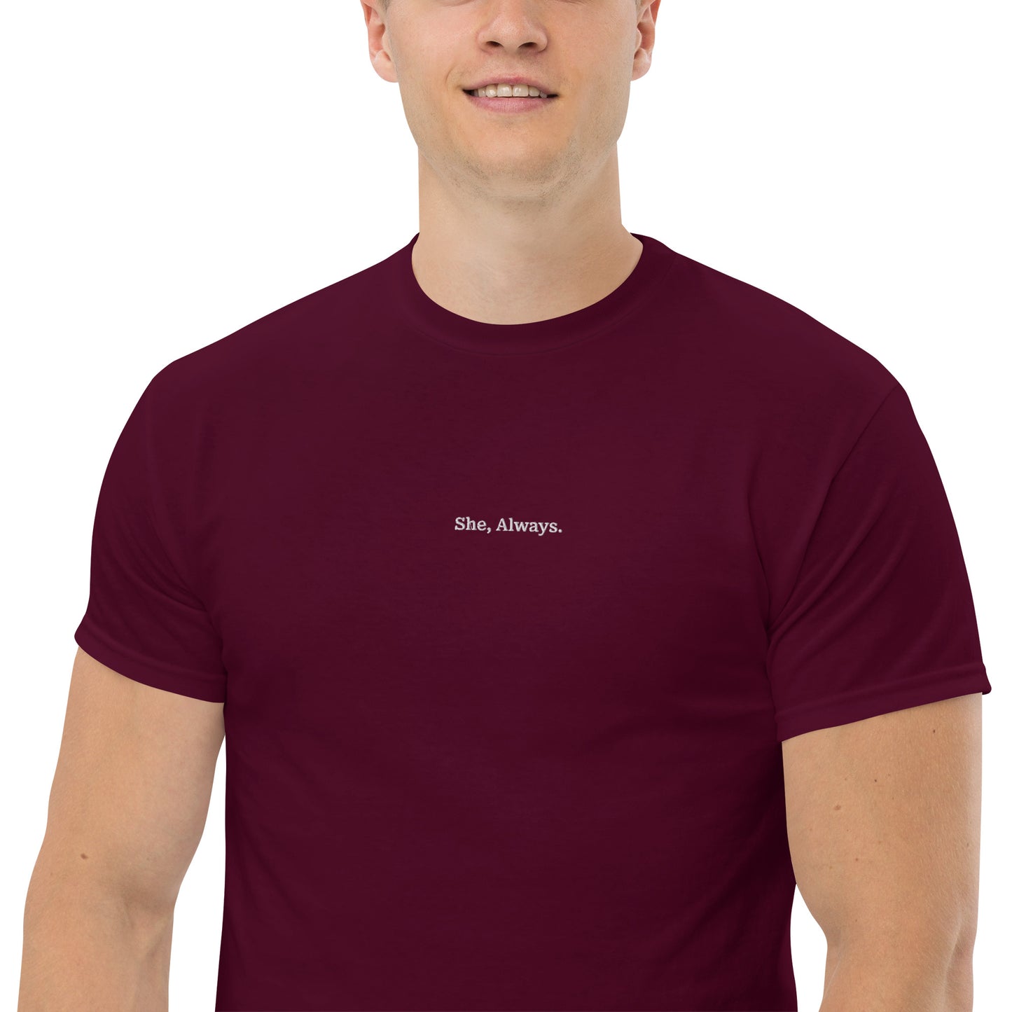 Close-up of Male model wearing maroon “She. Always.” unisex cotton T-shirt, supporting women’s empowerment.