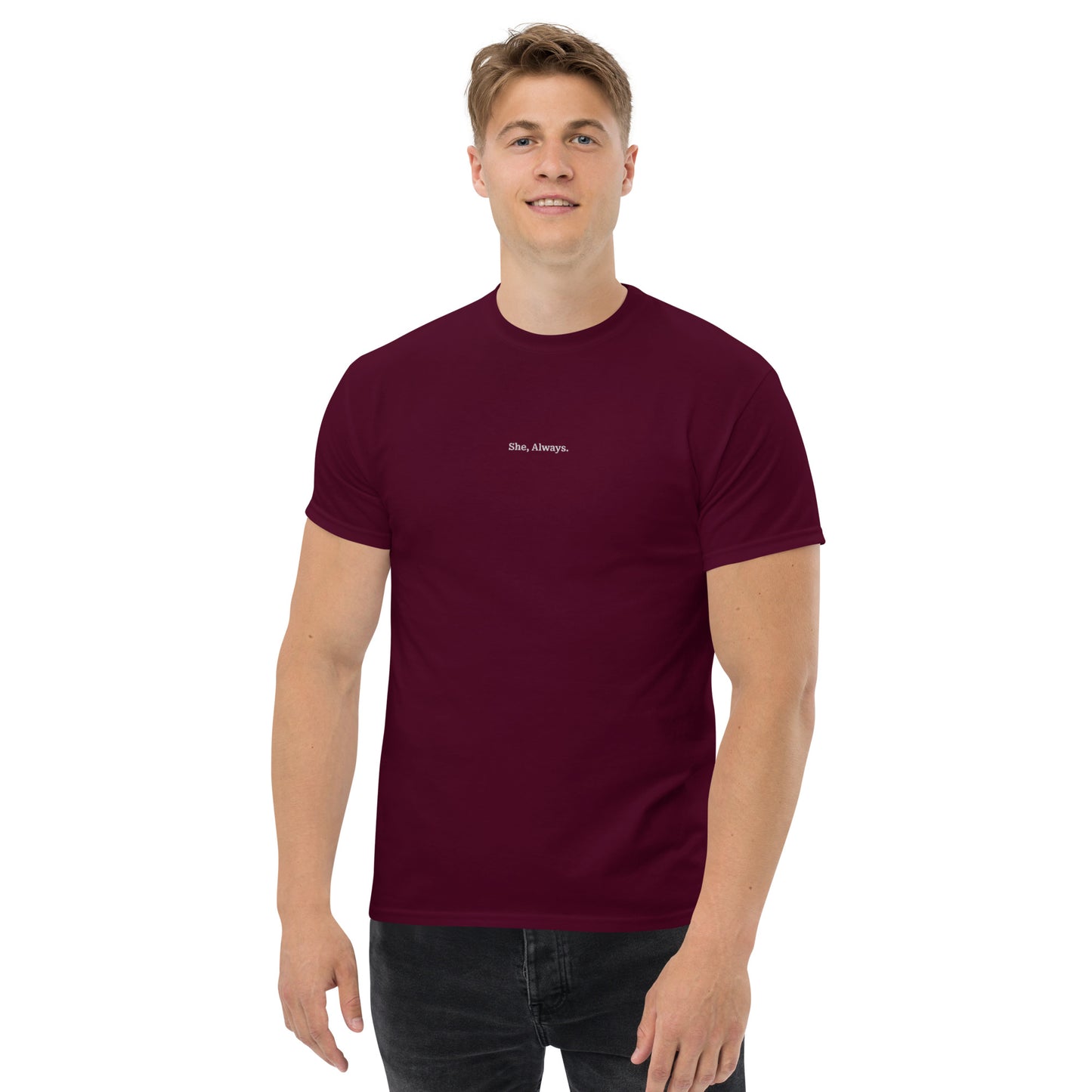 Male model wearing maroon “She. Always.” unisex cotton T-shirt, supporting women’s empowerment.