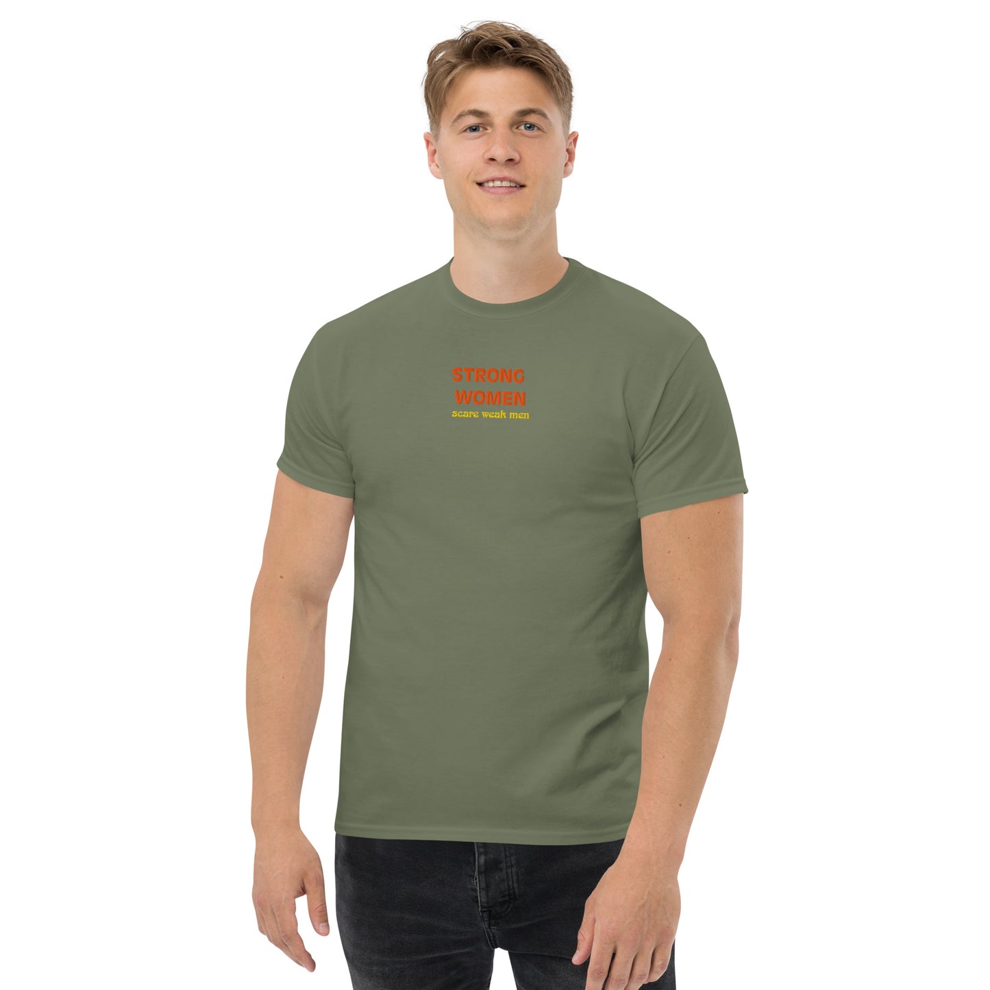 Male model wearing military green “Strong Women Scare Weak Men” unisex T-shirt, supporting women’s empowerment.