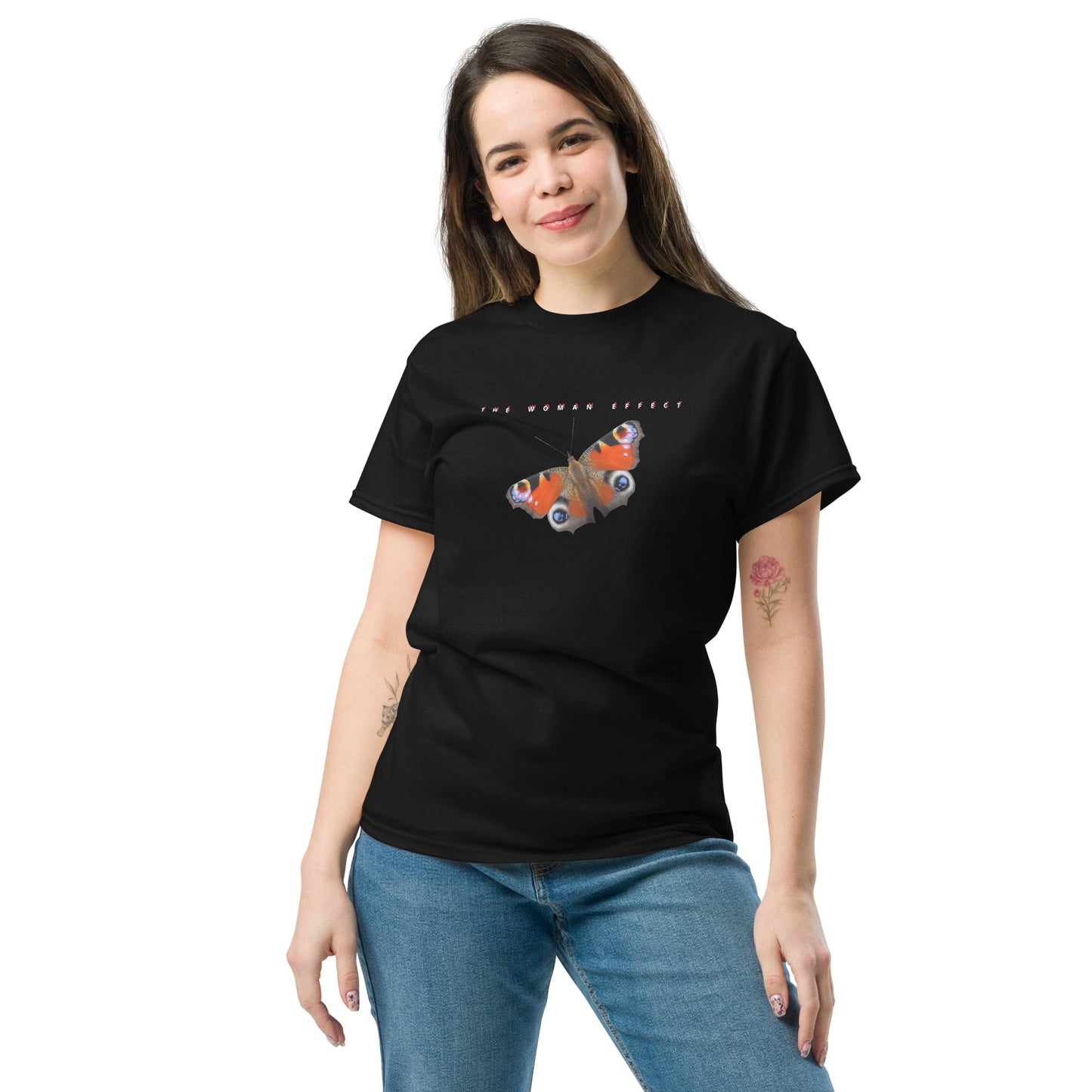 Female model wearing black “The Woman Effect” unisex T-shirt with butterfly illustration, celebrating women’s influence and transformation.