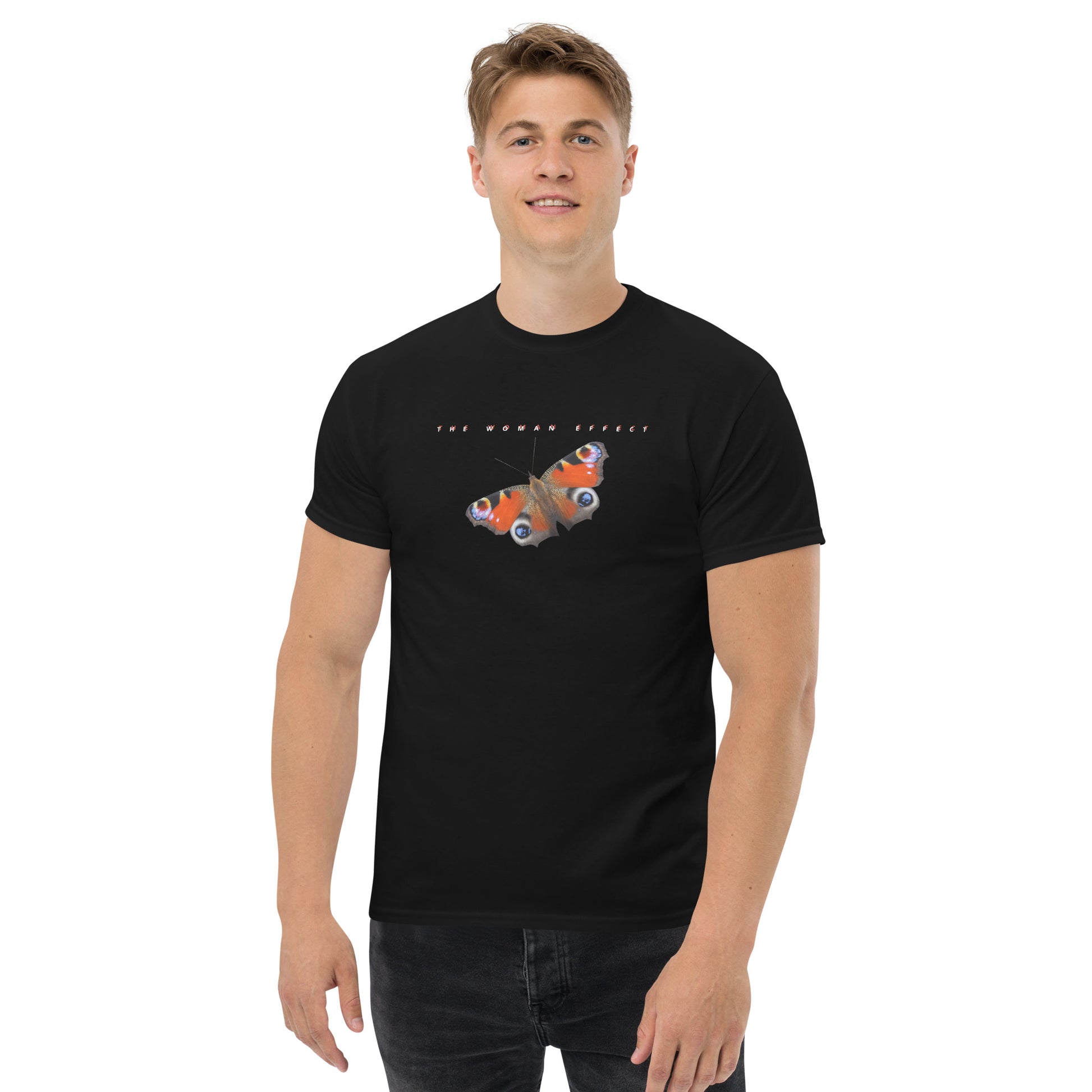 Male model wearing black “The Woman Effect” unisex T-shirt with butterfly illustration, showing support for women’s empowerment.