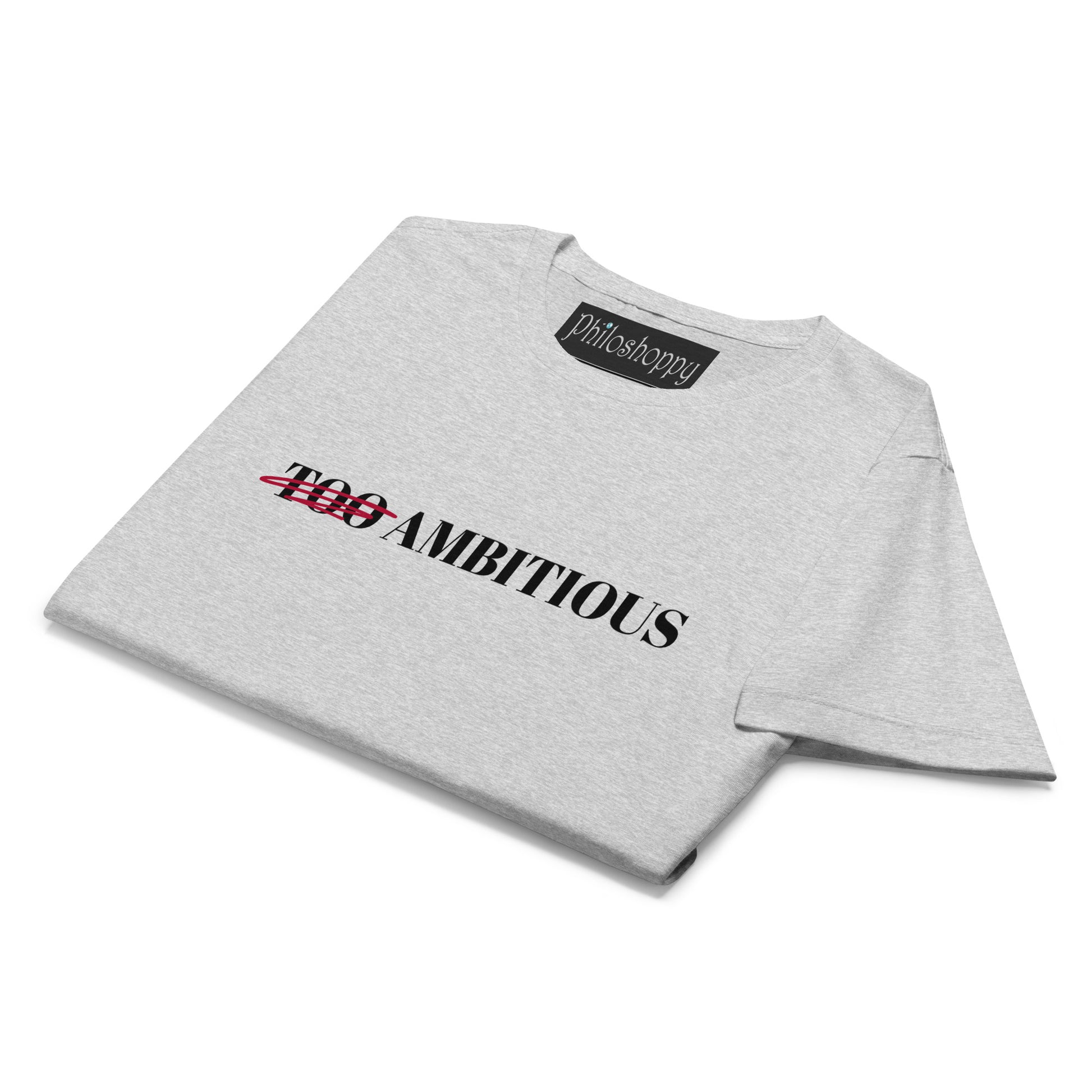 Folded grey women’s softstyle cotton T-shirt with “Too Ambitious” crossed-out empowerment design.