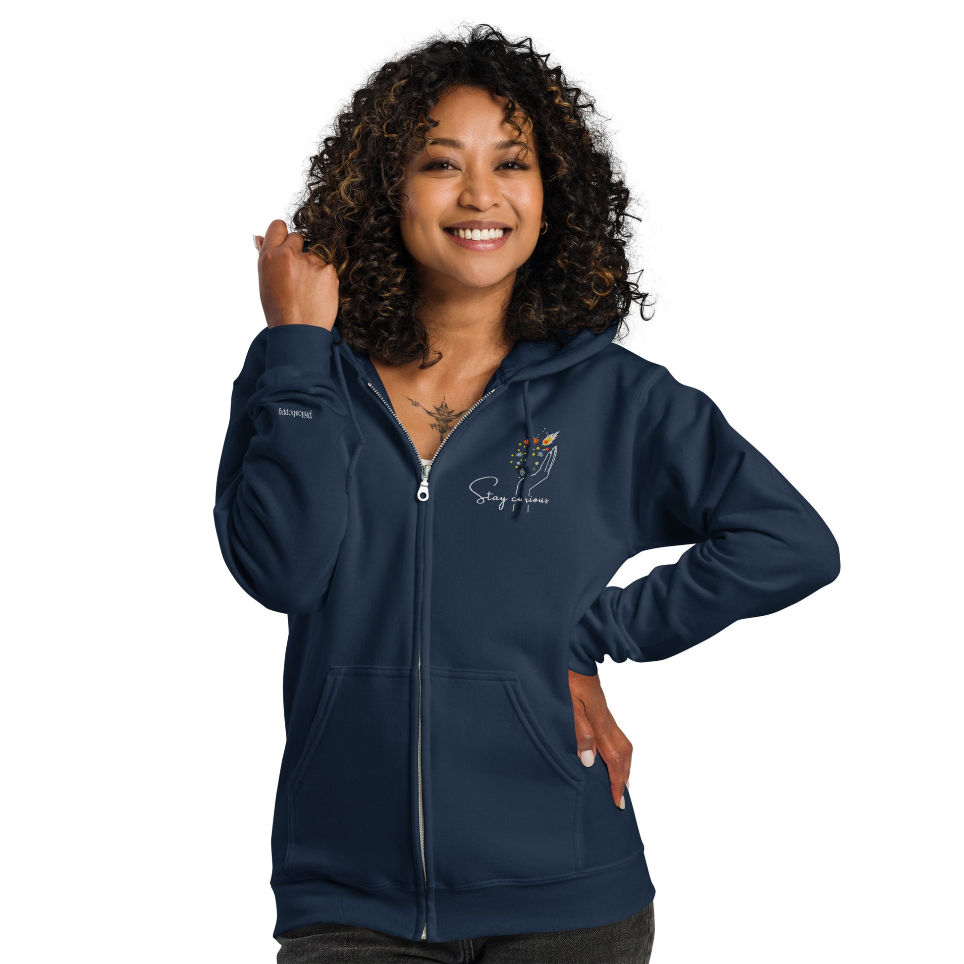 Navy blue hoodie with “Stay Curious” print and celestial hand illustration, unisex design celebrating imagination, exploration, and wonder.