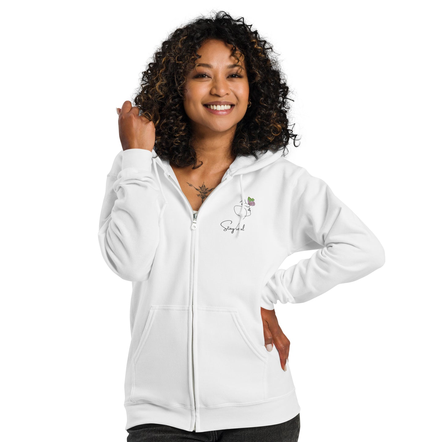 White zipped hoodie with “Stay Real” print and simple woman-and-butterfly artwork, unisex design symbolizing authenticity, calm, and natural beauty.