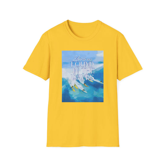 Yellow T-shirt from Philoshoppy featuring a surfer design and the phrase 'lost at sea, found in the waves', symbolizing self-discovery, surrender, and freedom through connection with nature.